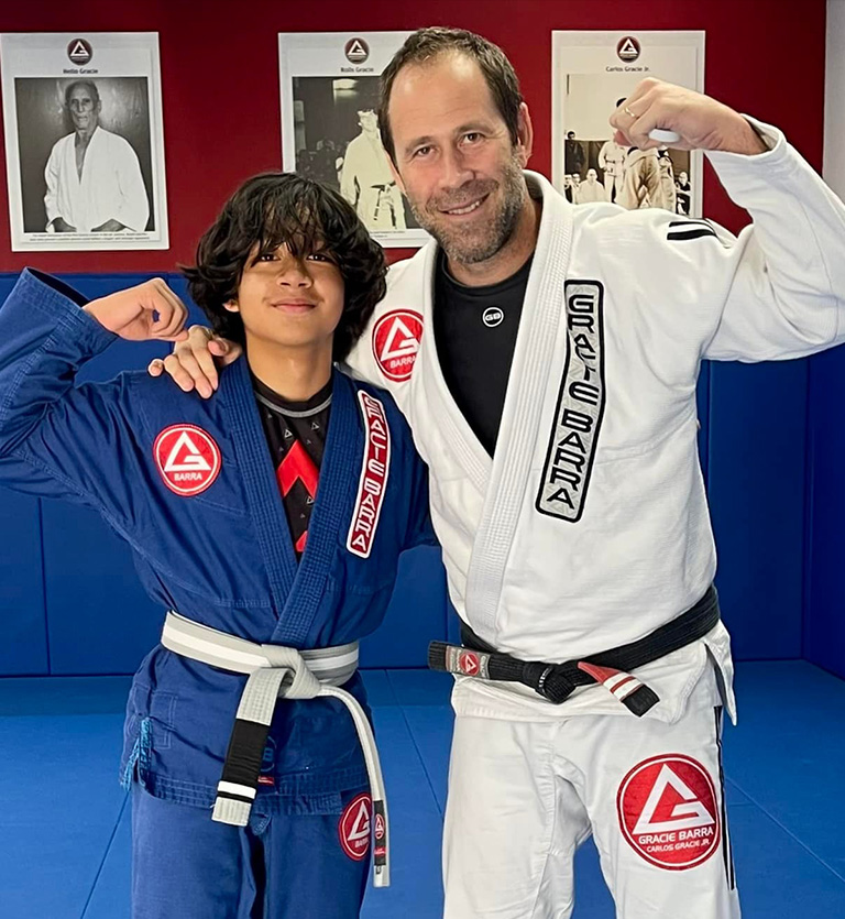 Kid earning a new belt with Martial arts professor